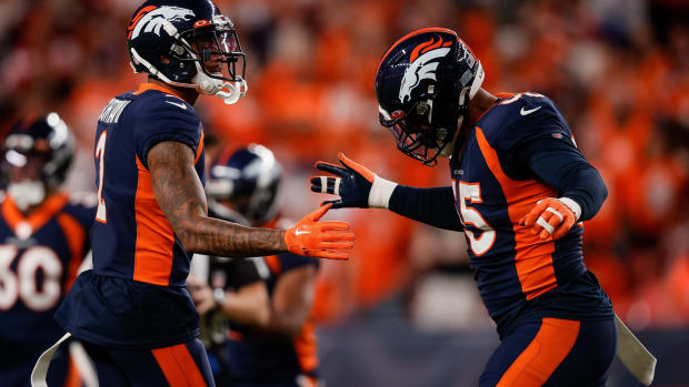 Denver Broncos cornerback Pat Surtain II (2) celebrates with linebacker Bradley Chubb (55) after a play in the first quarter against the San Francisco 49ers at Empower Field at Mile High.